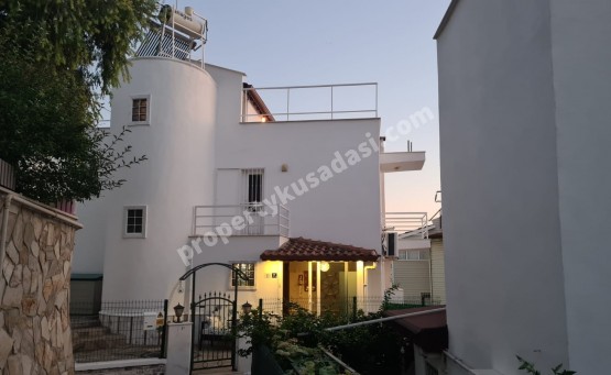 A detached villa with 3 bedrooms and a garden, close to the sea for sale in Kusadasi.